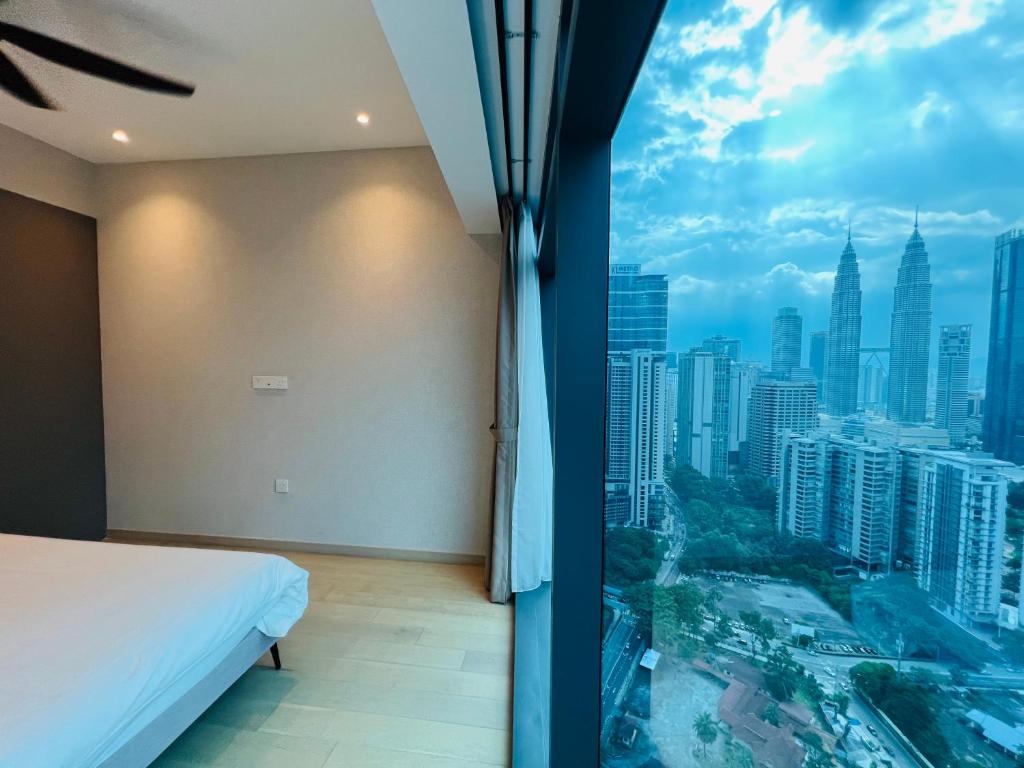 a bedroom with a view of a city at Eaton Residences KLCC - Luxury Apartment in Kuala Lumpur