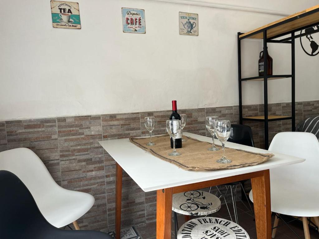 a table with a bottle of wine and glasses on it at Casa Vintage Bikes in Villa Marini
