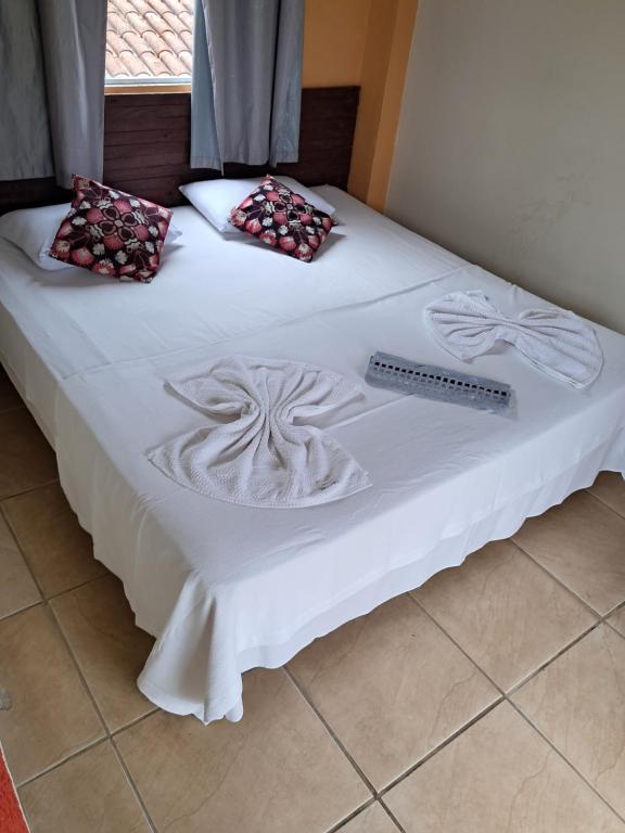 Postel nebo postele na pokoji v ubytování Suítes Praia das Toninhas