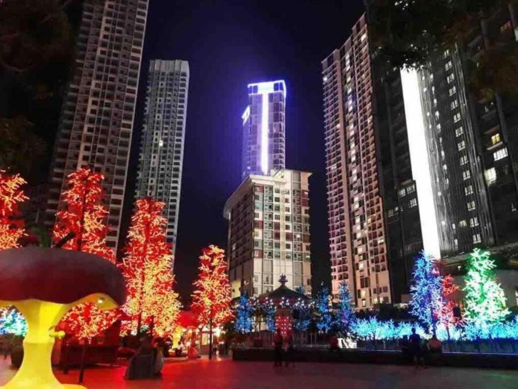 a city lit up at night with christmas trees and buildings at I-City Homestay at Shah Alam by Landmark in Shah Alam
