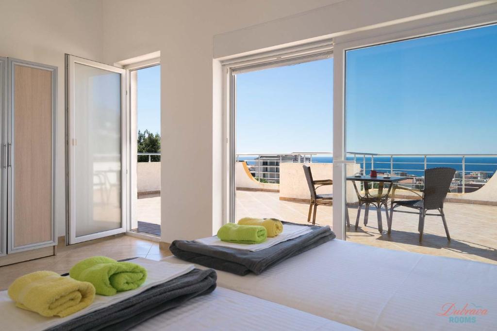 a living room with two bean bags and a view of the ocean at Dubrava Rooms in Dobra Voda