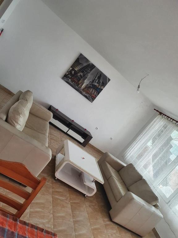 a living room with two chairs and a table at Vikendica Emily in Kovin