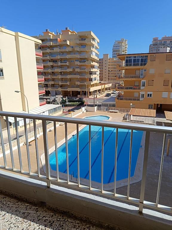 a balcony with a swimming pool and buildings at Cozy Beachside Apartment in Tavernes de Valldigna