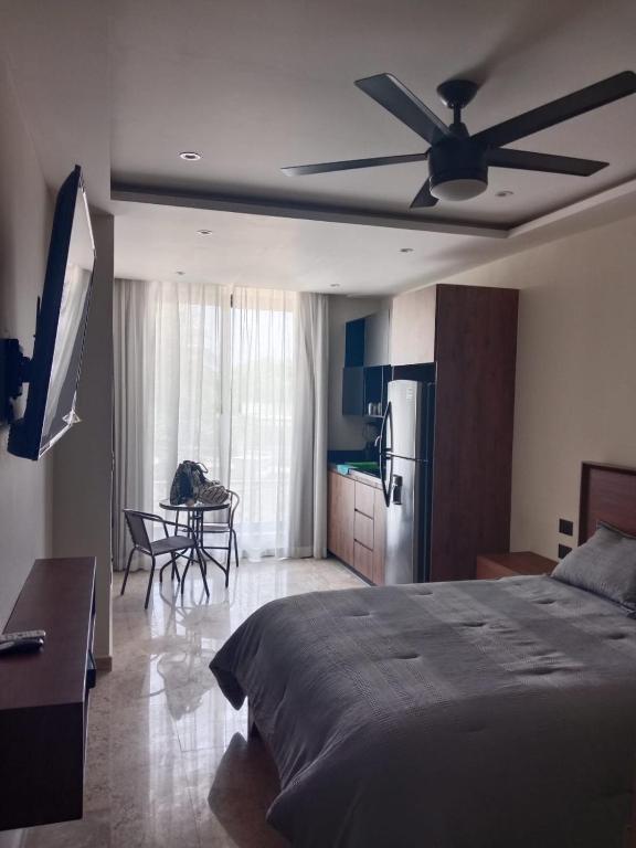 a bedroom with a bed and a ceiling fan at Turix 102 in Puerto Morelos