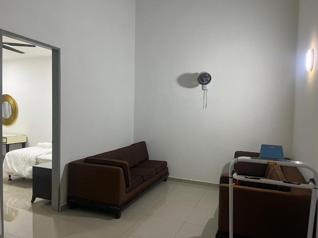 a living room with a couch and a chair at HOMESTAY Residensi Lambaian 2 Kajang in Kajang
