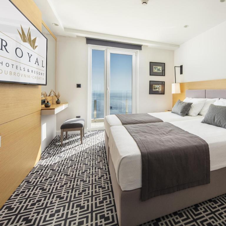 a hotel room with two beds and a window at Royal Neptun Hotel in Dubrovnik