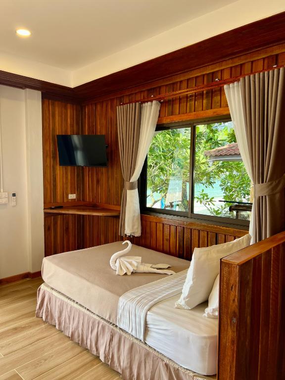 Ein Bett oder Betten in einem Zimmer der Unterkunft Pen's Bungalow Koh Phangan