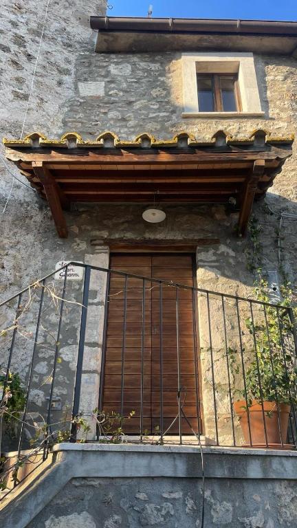 a building with a window and a balcony at Locanda San Giovanni in Castiglione in Teverina