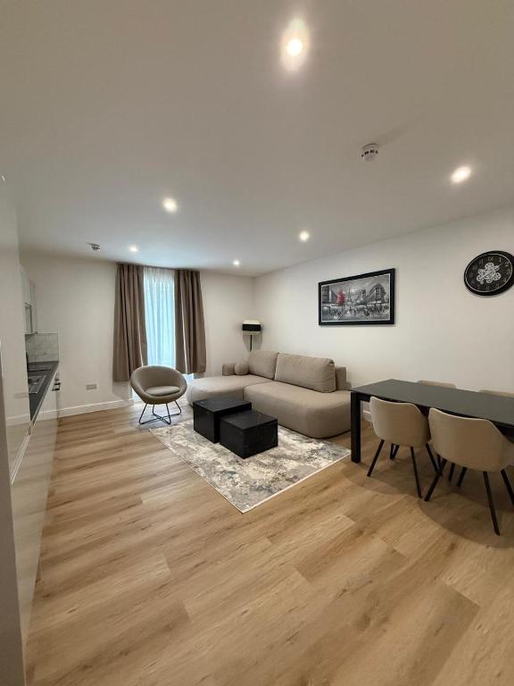 a living room with a couch and a table at Luxury Sovereign House in Brighouse