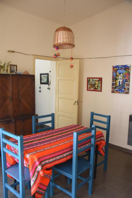 a dining room table and chairs with a colorful tablecloth at La casa de Mirta Habitaciones en Córdoba in Cordoba