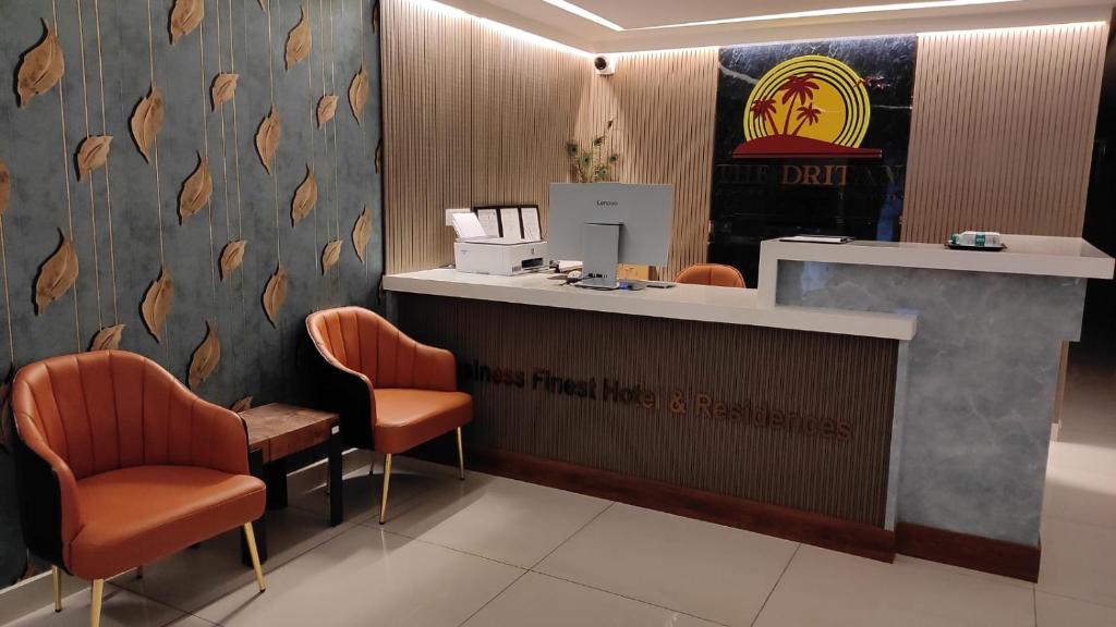 a waiting room with orange chairs and a counter at The Dritan in Bengaluru
