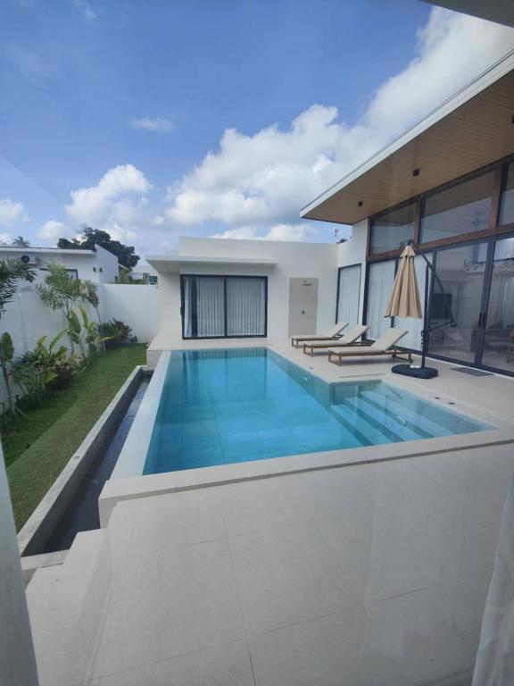 a swimming pool in the backyard of a house at Samui Luxury villas -By Samui Rental Villas in Nathon Bay