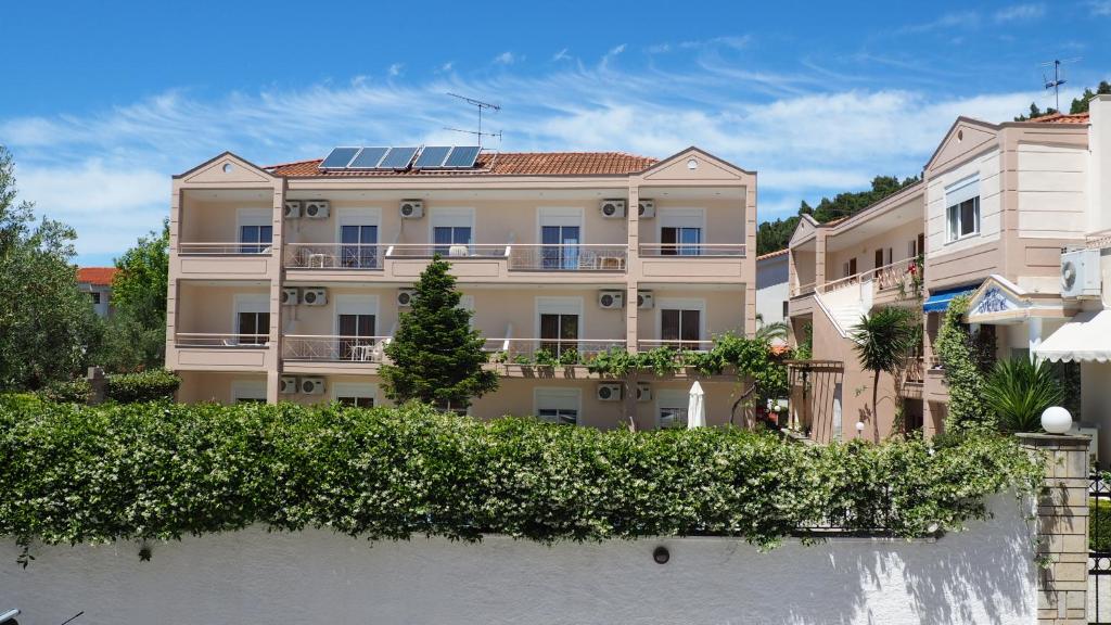 an apartment building with solar panels on the roof at Evridiki Hotel in Fourka
