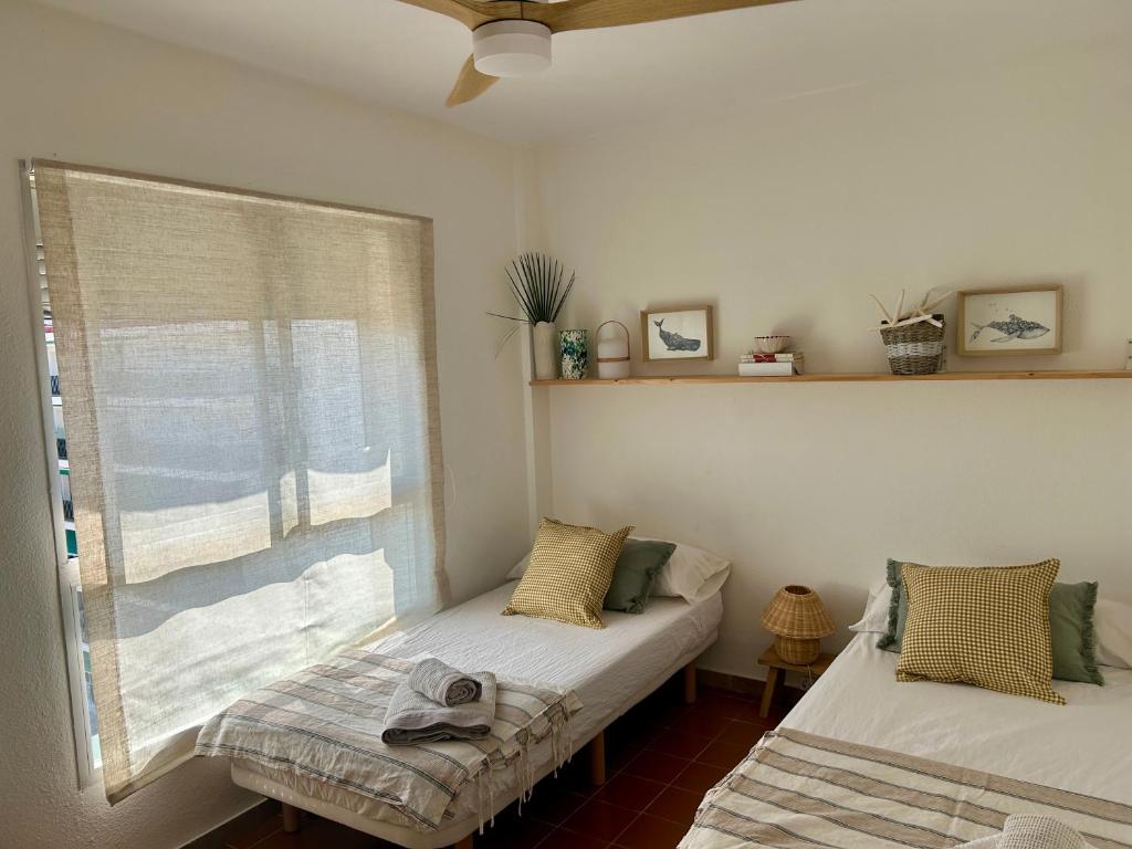 A bed or beds in a room at MIAMI PLAYA SIRENS en Cala Sirenas FREE WIFI