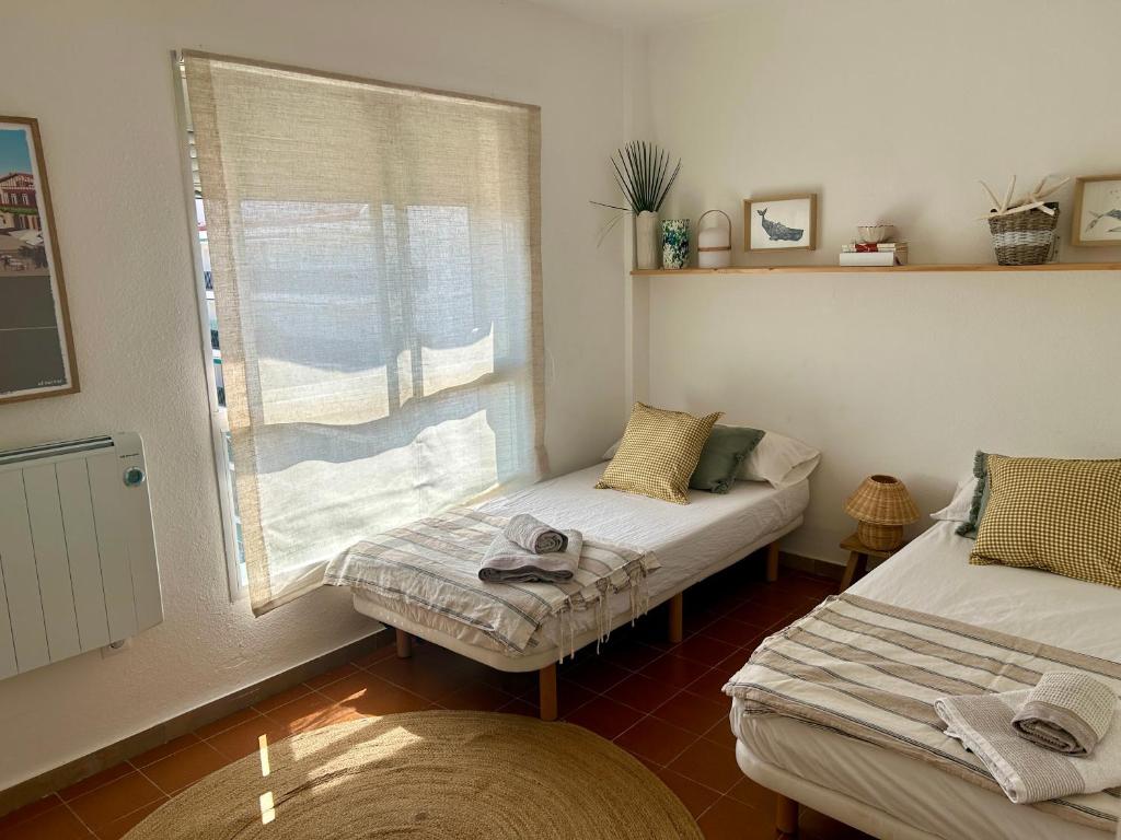 A bed or beds in a room at MIAMI PLAYA SIRENS en Cala Sirenas FREE WIFI