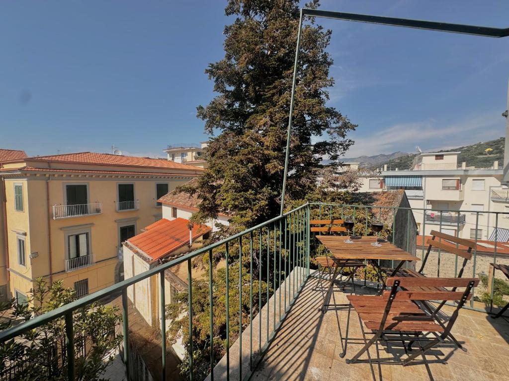 a balcony with a table and chairs on a building at Cottage Fabrizio apartment surrounded by greenery in the center in Sorrento
