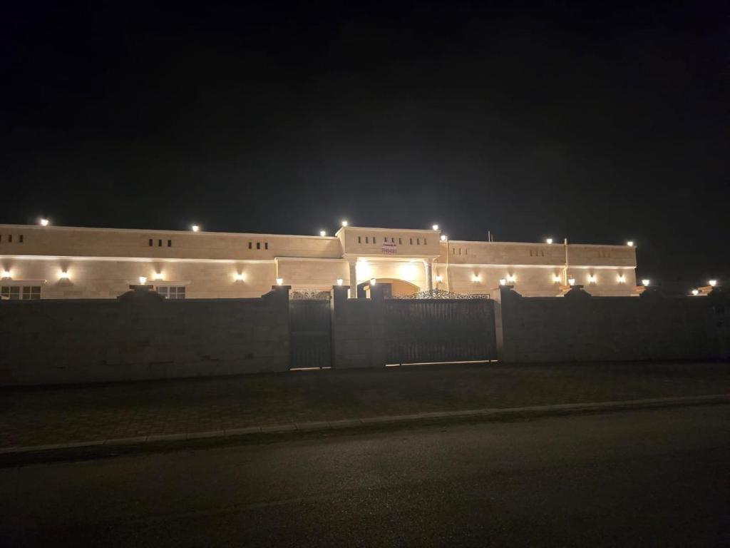 a building lit up at night with lights on it at شاليه صحلنوت sahalnoot chalet in Salalah