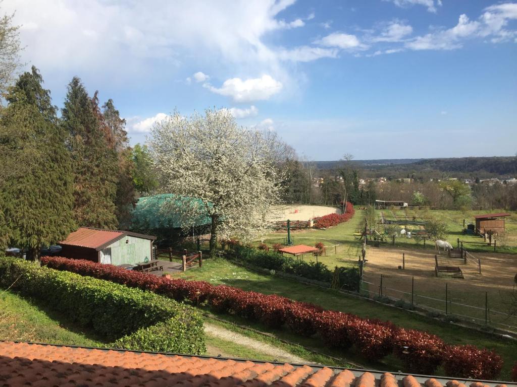 a view of a park with flowers and a fence at Agriturismo Tenuta Blueberry - Glicine in Varallo Pombia