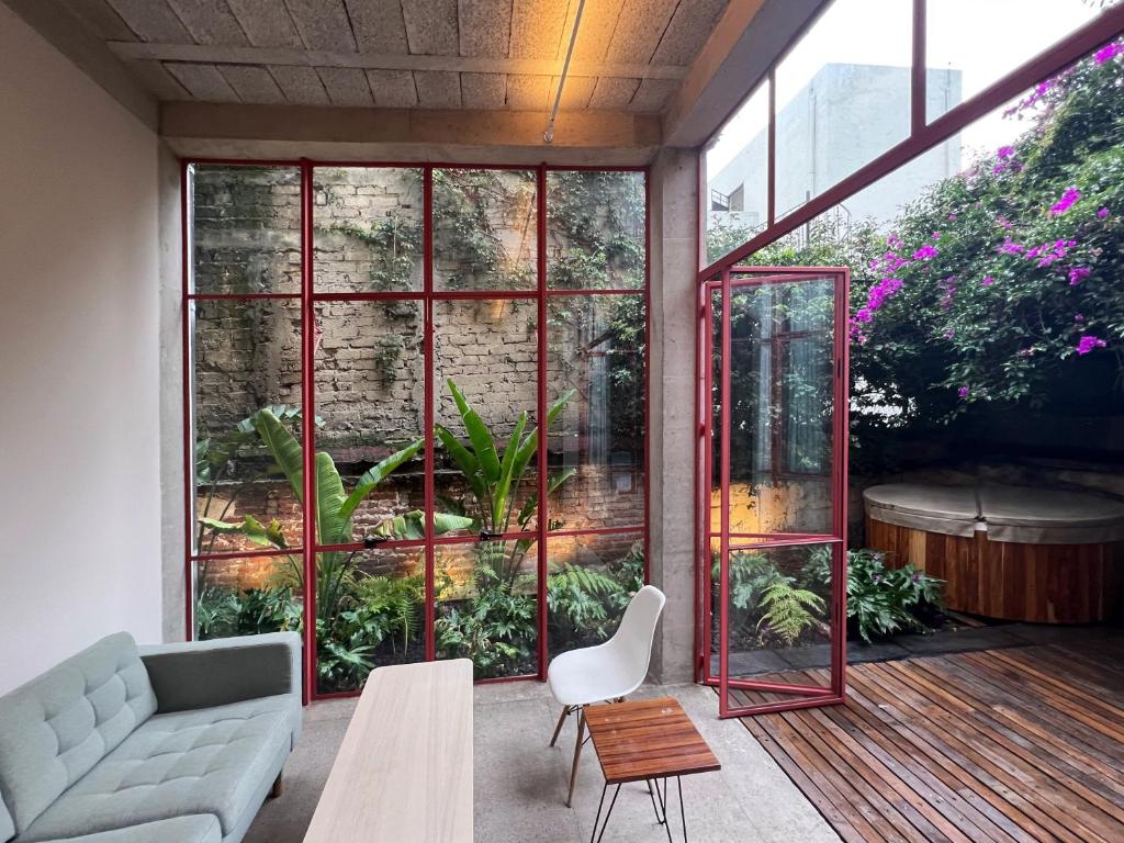a living room with a couch and a table at Xolo Condesa in Mexico City