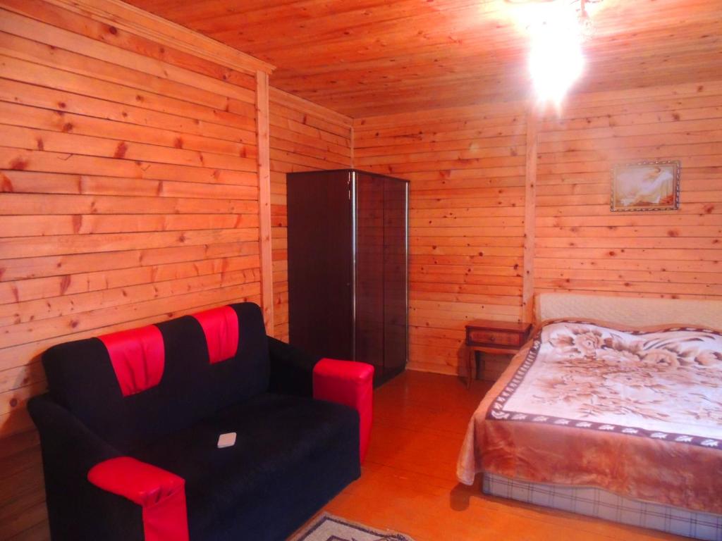 a room with a bed and a chair in a cabin at Old City in Borjomi
