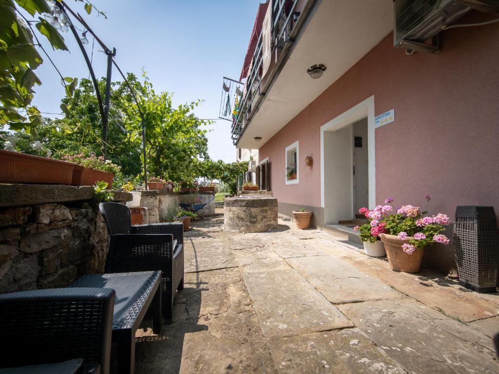 a patio with benches and flowers and a building at LUNA APARTMENTS Quiet Retreat, Close to Koper, AirCon, Parking in Ankaran
