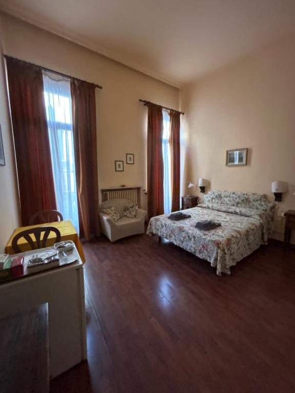 a room with two beds and a couch in it at Bed and Breakfast Querini San Marco in Venice