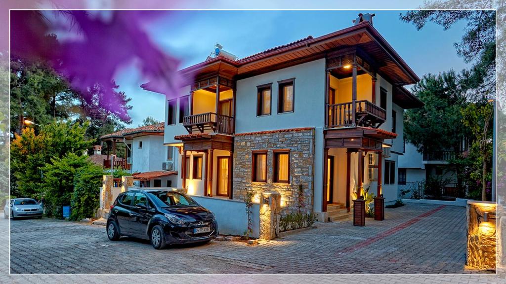 a car parked in front of a house at Alp Suites Lavanta in Akyaka
