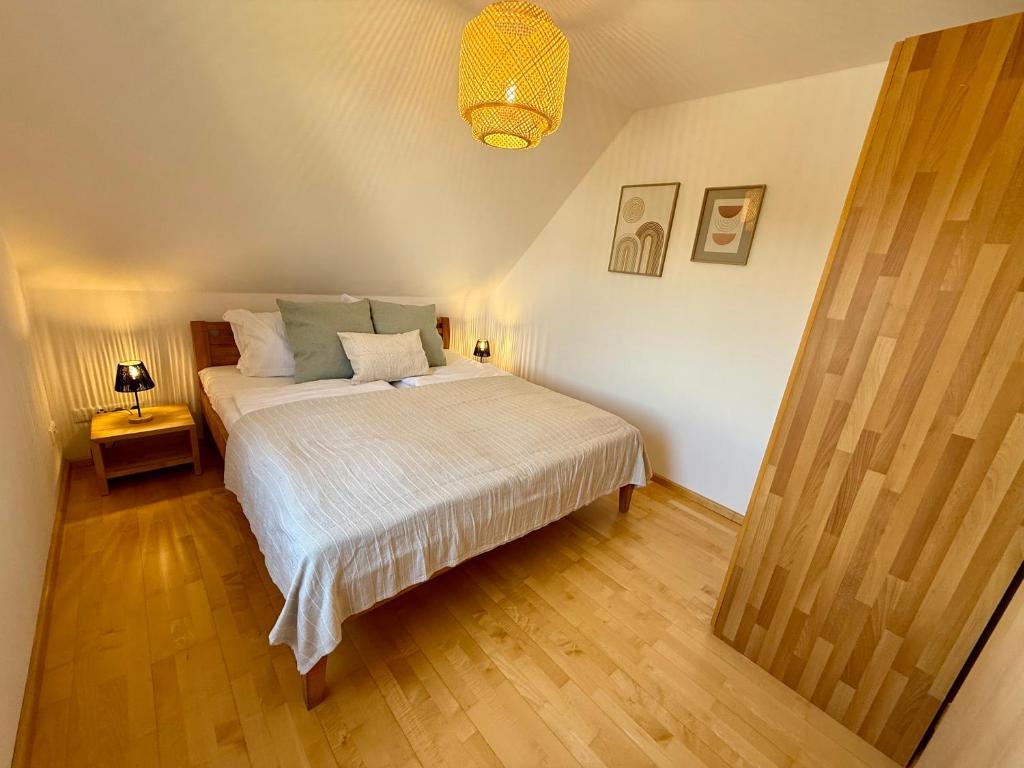 a bedroom with a large bed in a room at ZK Living Ferienwohnung OG in Kleinkötz