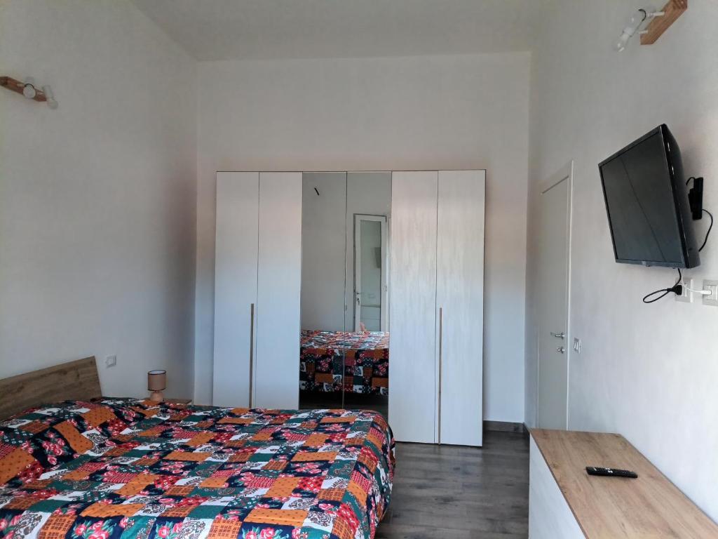 a bedroom with a bed and a flat screen tv at Appartamento Montevago Centro in Montevago
