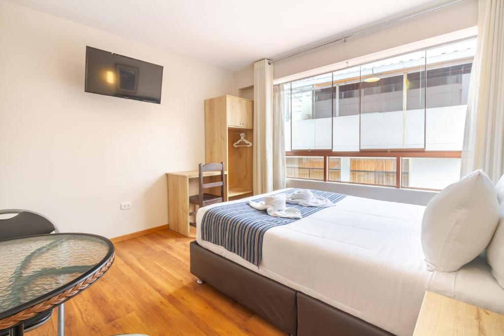 Postel nebo postele na pokoji v ubytování Cusco Hostal Qolla Wasi-II