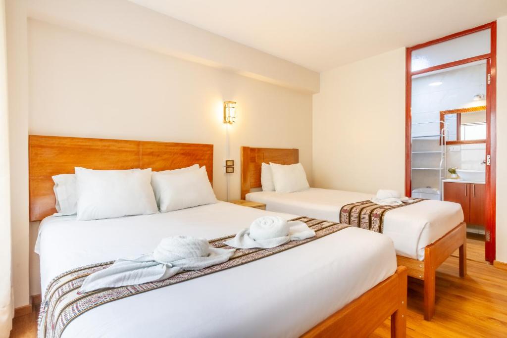 Postel nebo postele na pokoji v ubytování Cusco Hostal Qolla Wasi-II