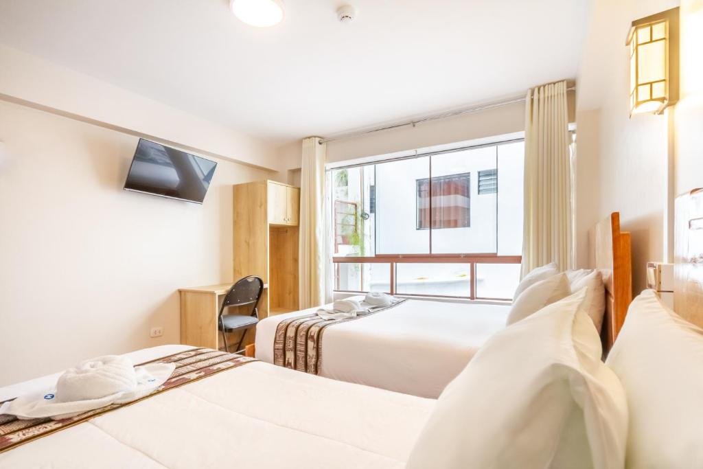 Postel nebo postele na pokoji v ubytování Cusco Hostal Qolla Wasi-II