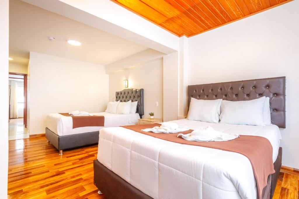 Postel nebo postele na pokoji v ubytování Cusco Hostal Qolla Wasi-II
