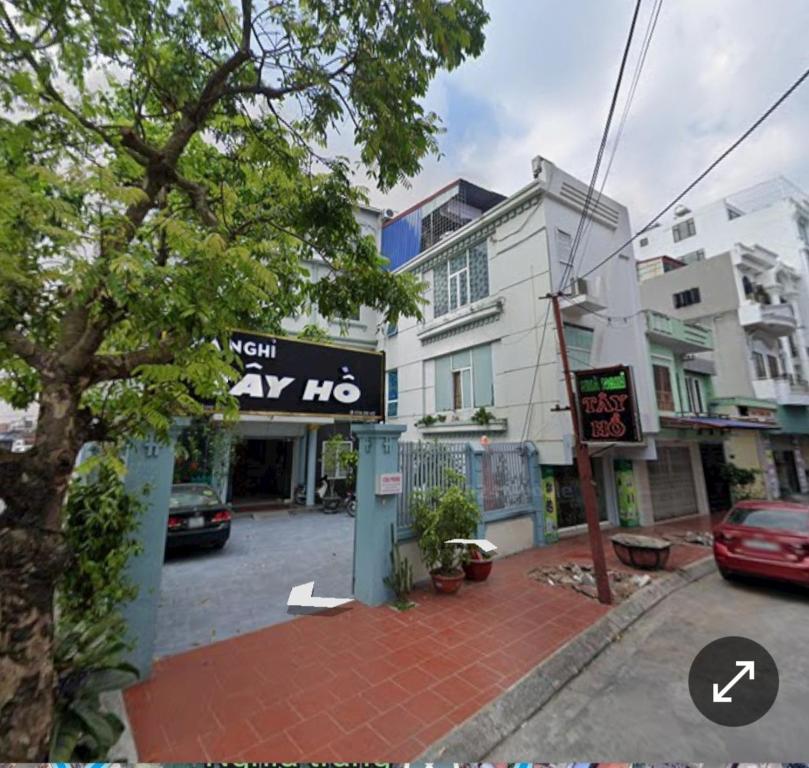 a building with a sign on the side of a street at Motel TÂY HỒ in An Khê