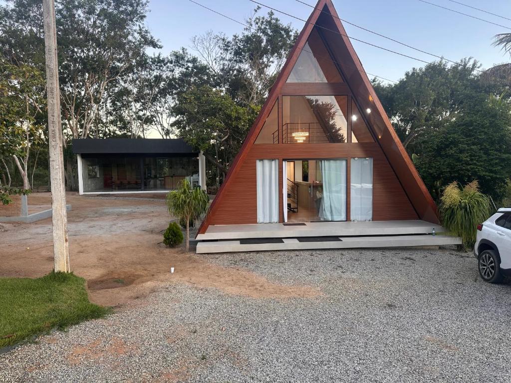 a small house with a triangular roof at Morada das colinas in Garanhuns