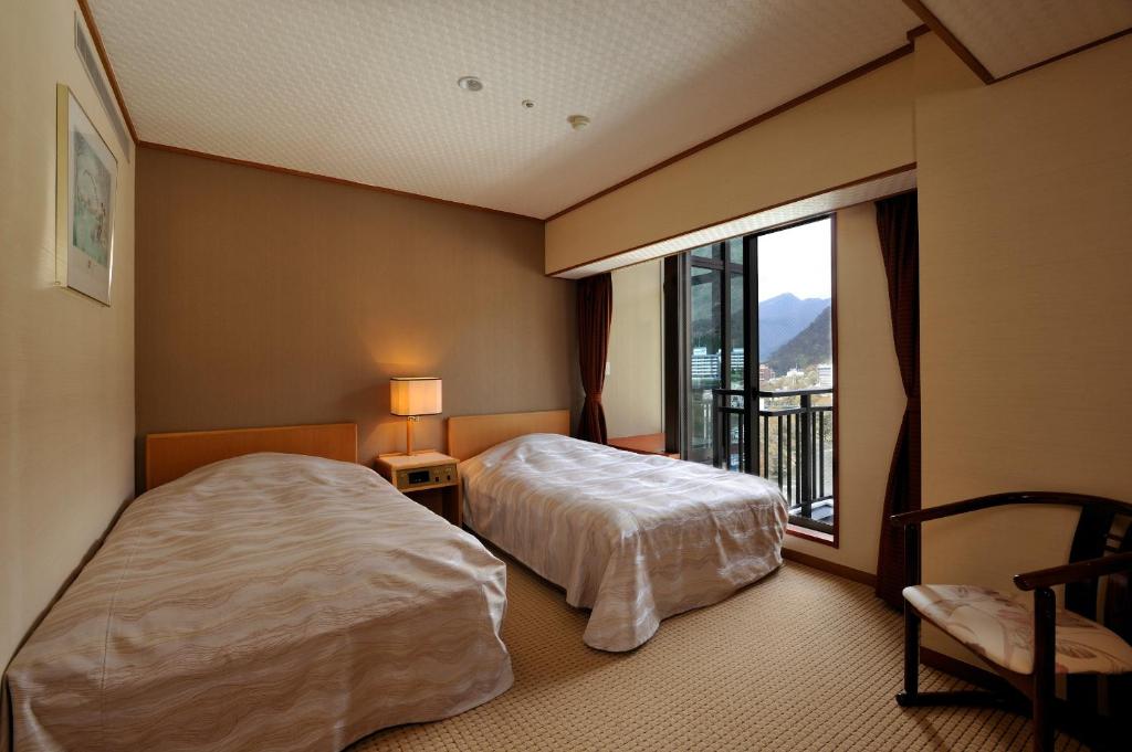 Postel nebo postele na pokoji v ubytování Kinugawa Hotel Mikazuki