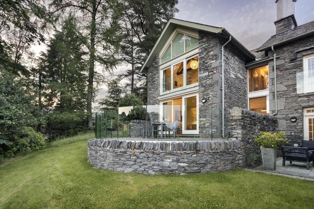 a stone house with a stone wall at Take Five in Ambleside