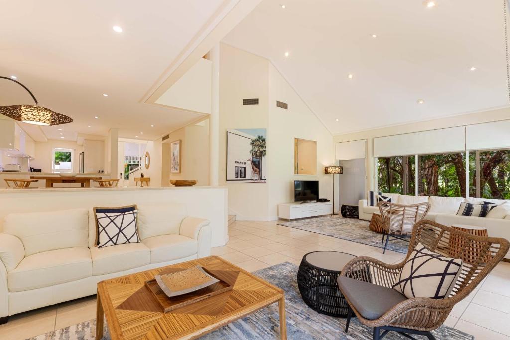 a living room with a couch and a table at Mirage Resort Villa 438 with access to Sheraton Facilities in Port Douglas