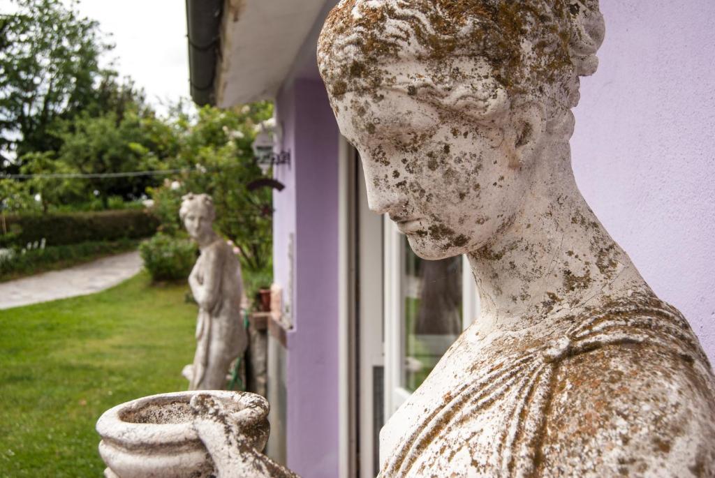 posąg kobiety trzymającej wazę w obiekcie Amarcord w mieście Bagnoregio