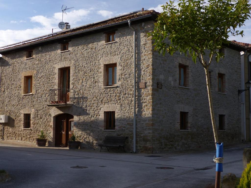 un edificio de piedra con un banco delante en Casa Rural Iturrieta, en Adiós
