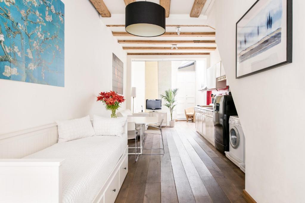 a living room with a white couch and a table at GH Amsterdam in Amsterdam