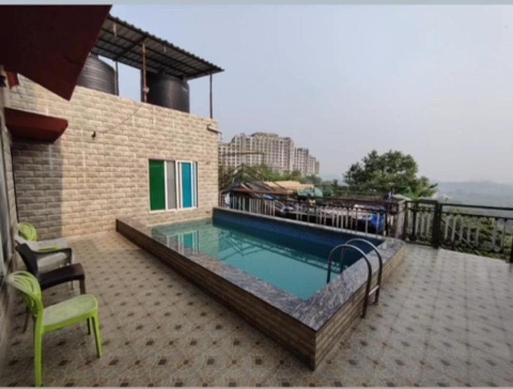 a swimming pool on top of a building at Z villa in Mumbai