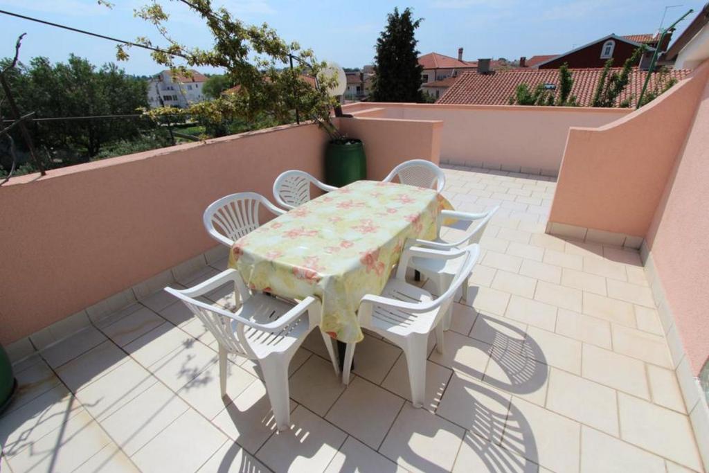a table and chairs sitting on a patio at Apartments Peteh in Rovinj