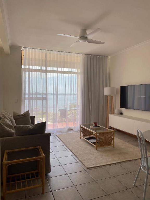 a living room with a couch and a flat screen tv at Makai ‘Toward the Sea’ in Port Lincoln