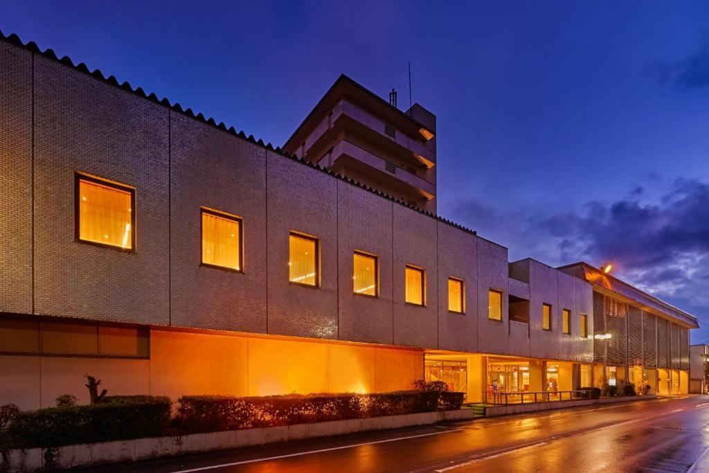 a building on a city street at night at Ooedo Onsen Monogatari Awazu Grand Hotel in Komatsu