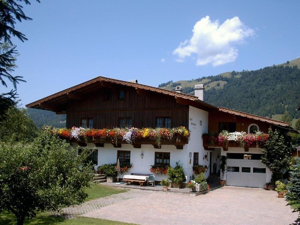 a house with flowers on the side of it at Haus Sebastian in Walchsee