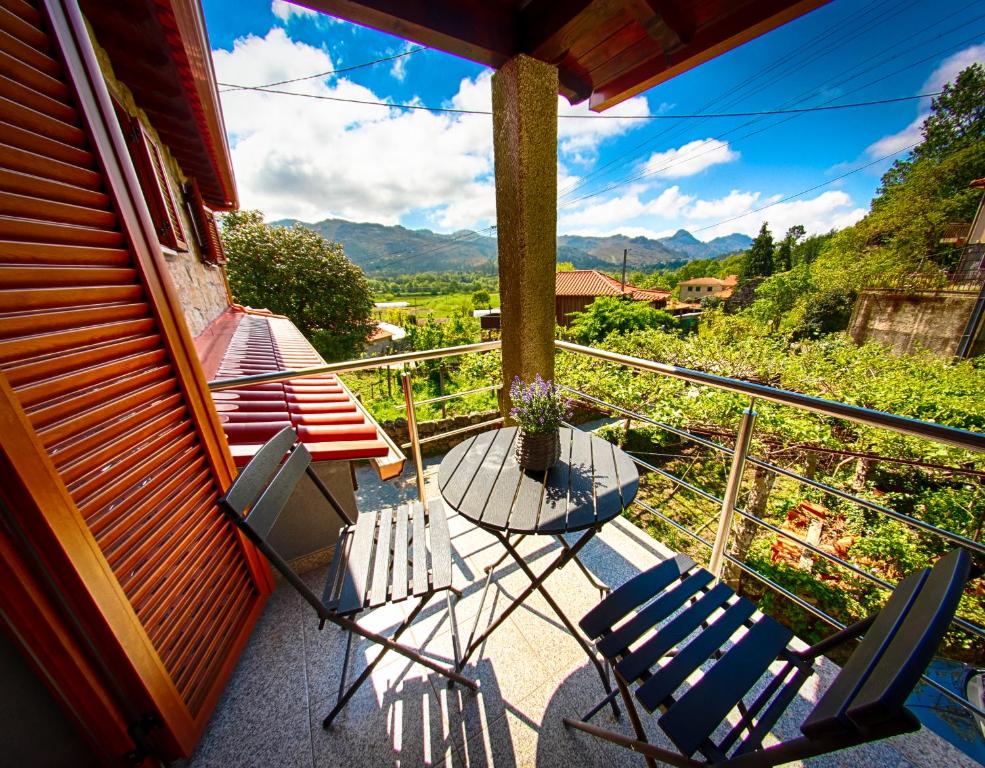 a balcony with chairs and a view of the mountains at Casa da Fonte in Campo do Gerês