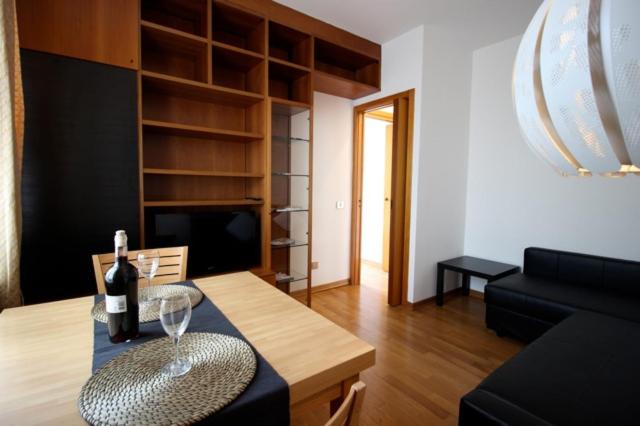 a living room with a table with a wine glass on it at Apartament Monte Mario in Rome