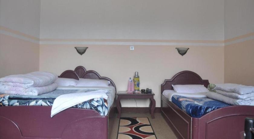 Postel nebo postele na pokoji v ubytování Stupa Resort