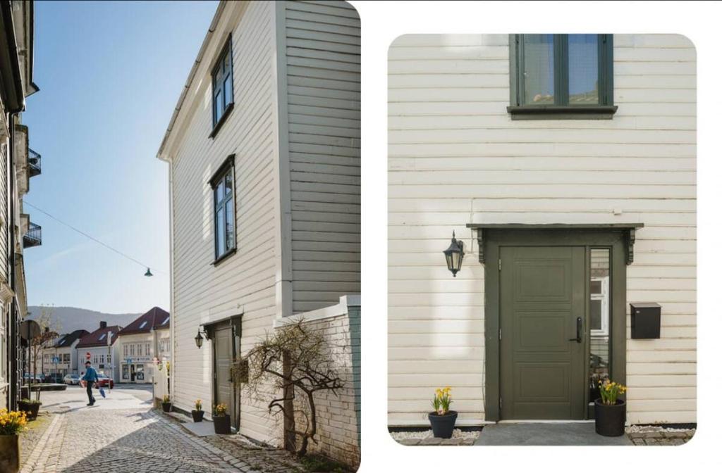 a building with a green door next to a street at Central & Charming in Bergen in Bergen
